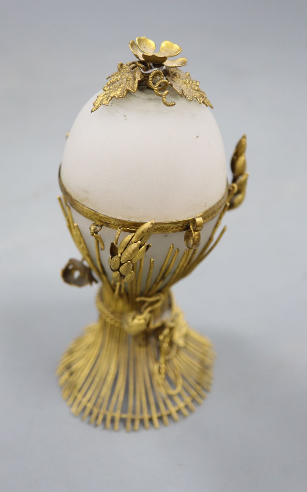 An opaque glass gilt metal egg-shaped necessaire